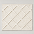 Deep Diamond Mat in milk white: a hand-woven cotton bath mat with a deep knotted diamond lattice in relief