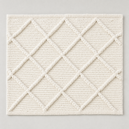 Deep Diamond Mat in milk white: a hand-woven cotton bath mat with a deep knotted diamond lattice in relief