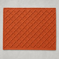 Diamond Mat in seville orange: a hand-woven cotton bath mat with a close knotted diamond weave