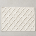 Diamond Mat in warm white: a hand-woven cotton bath mat with a close knotted diamond weave