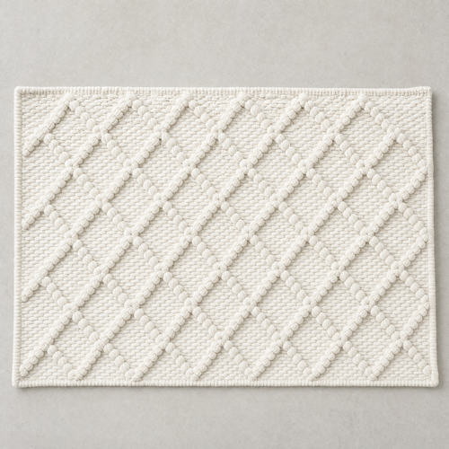 Diamond Mat in warm white: a hand-woven cotton bath mat with a close knotted diamond weave