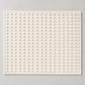 Dot Mat in warm white: a regular grid of raised cotton knots on a flat woven ground