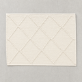 Open Diamond Mat in warm white: knotted diamond outlines over a flat woven cotton ground